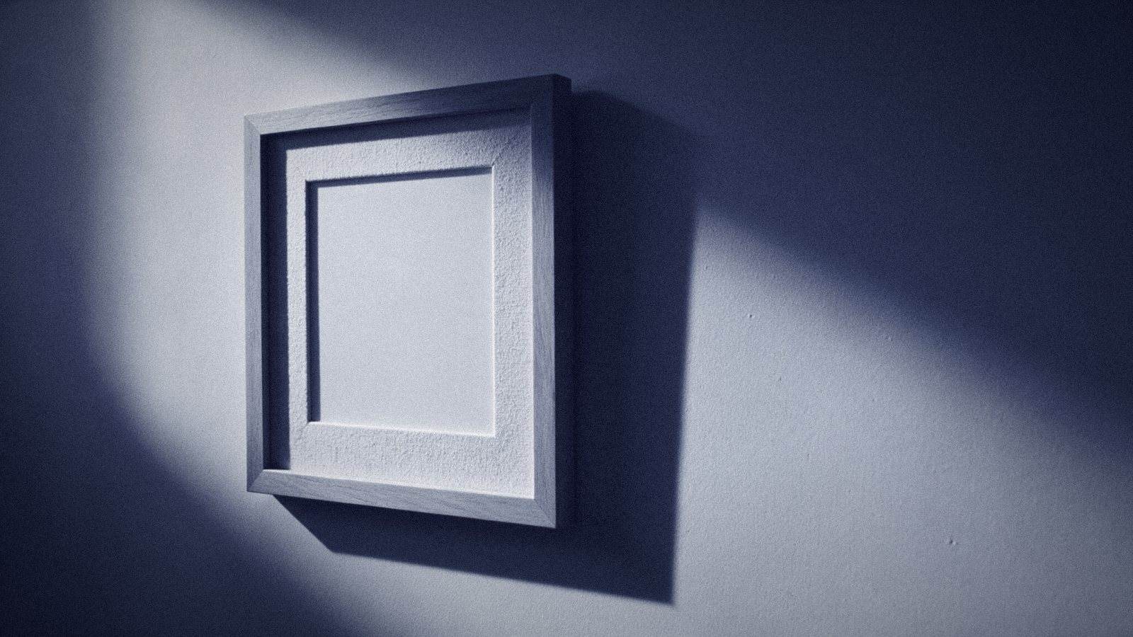 Fractional Cmo Training: What It Covers And What It Misses 5 An Empty Picture Frame On A Plain Wall Lit By A Hard Diagonal Shaft Of Light, The Mount Inside Completely Blank