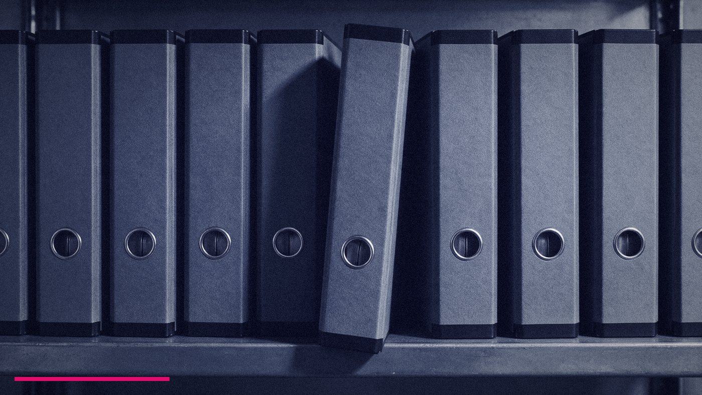 Fractional Cmo Training: What It Covers And What It Misses 2 A Tight Row Of Identical Unlabelled Ring Binders On A Shelf With One Tipped Out Of Line, Standing For Courses That All Teach The Same Six Modules